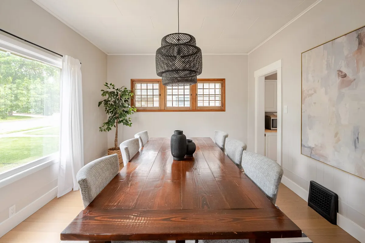 Farmhouse dining table for six by a picture window